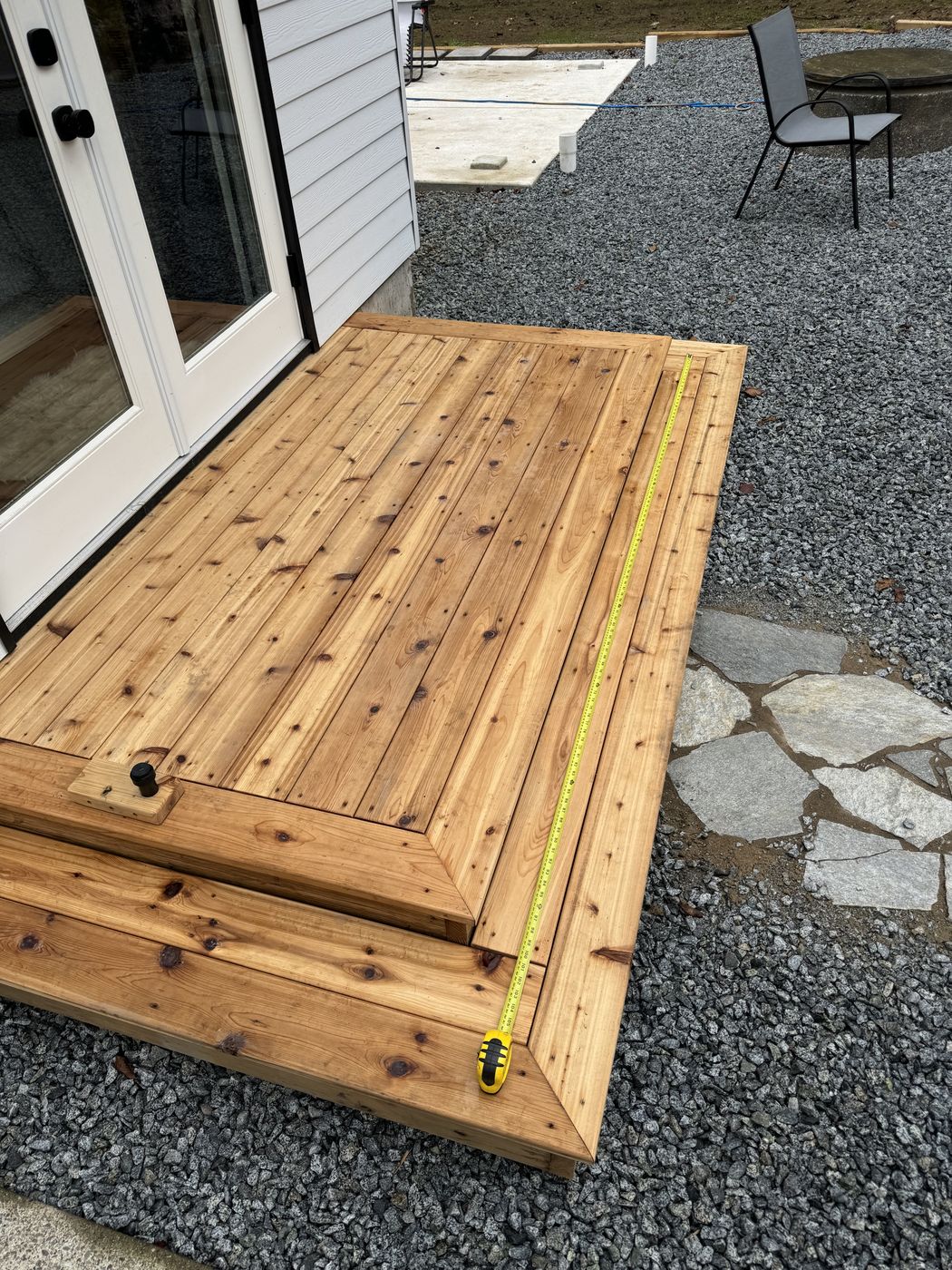 Custom cedar table top under construction with a tape measure